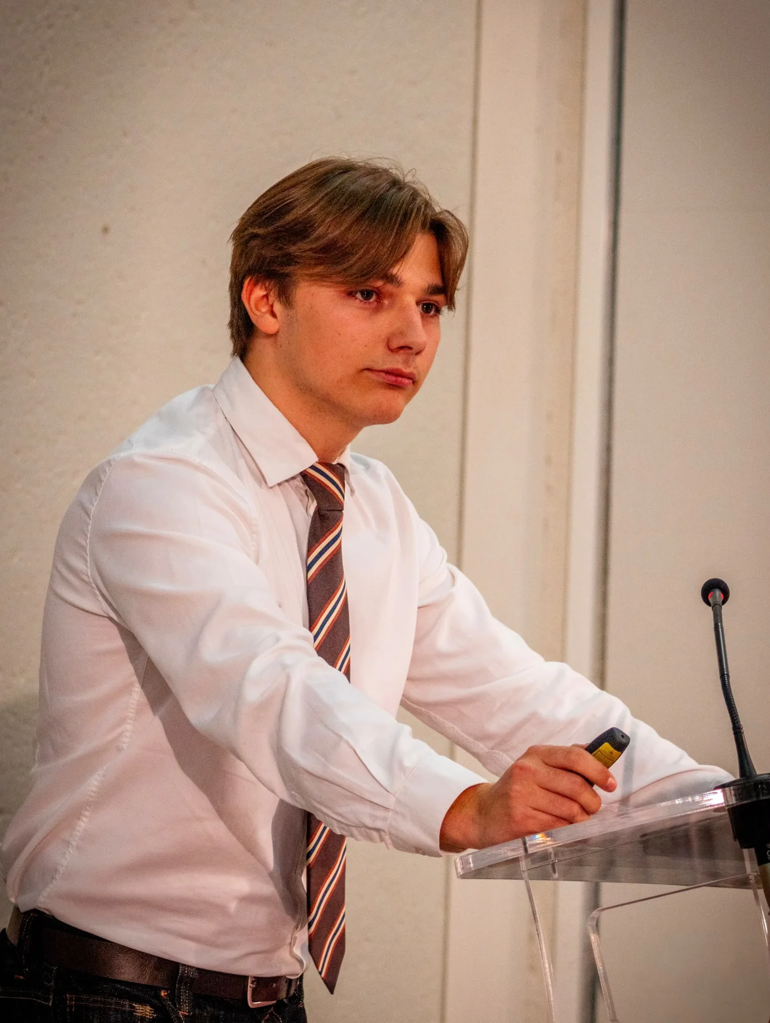 Thimotei speaking at a lectern